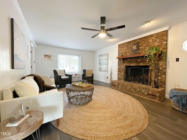 living area featuring ornamental molding, a ceiling fan, a fireplace, and wood finished floors