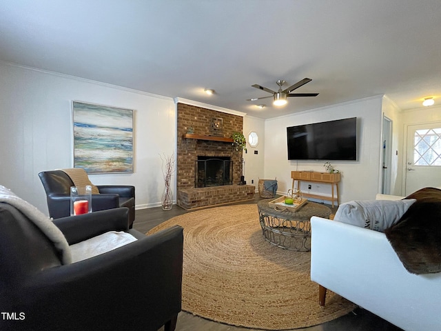 living room with a ceiling fan, a fireplace, crown molding, and wood finished floors