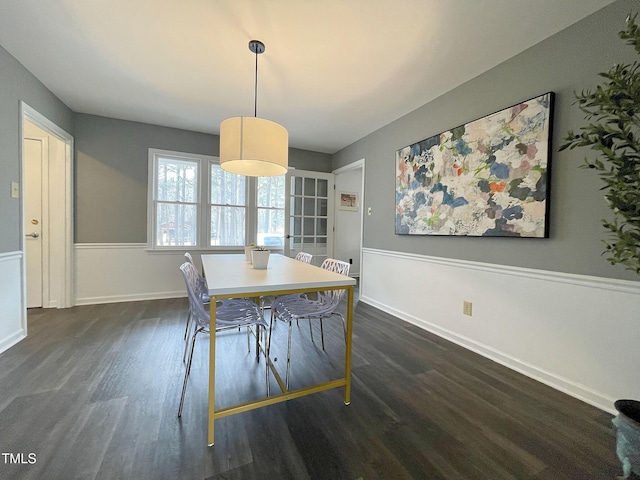 unfurnished dining area with dark wood-style floors and baseboards