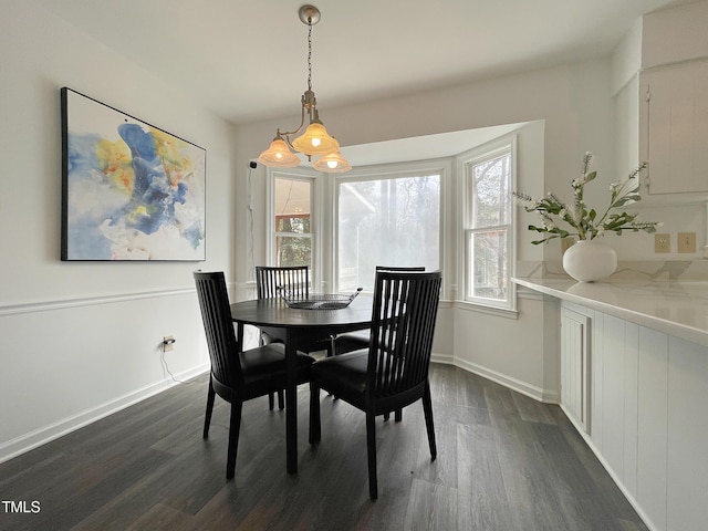 dining area with dark wood-style floors and baseboards