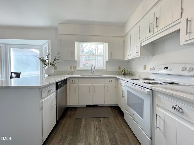 kitchen featuring electric stove, stainless steel dishwasher, dark wood-type flooring, white cabinetry, and a sink