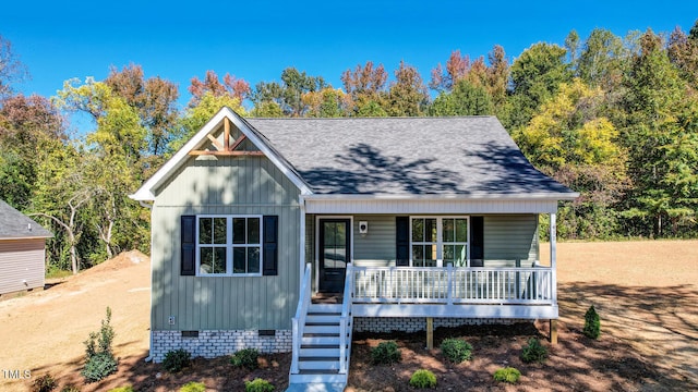 view of front of property with a porch, crawl space, and a shingled roof