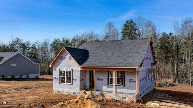 unfinished property with crawl space, covered porch, and a shingled roof