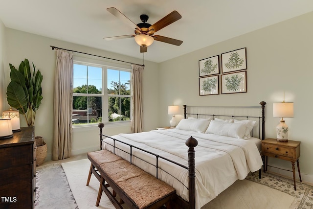 bedroom with a ceiling fan and baseboards