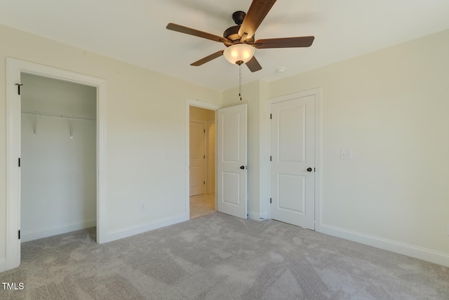 unfurnished bedroom with carpet floors, a ceiling fan, baseboards, and a closet