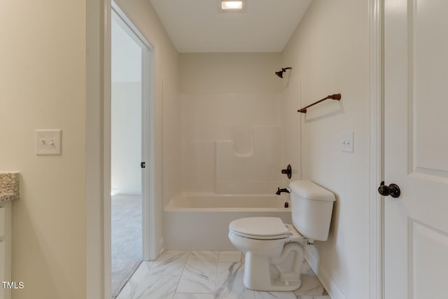 bathroom featuring marble finish floor, bathtub / shower combination, and toilet