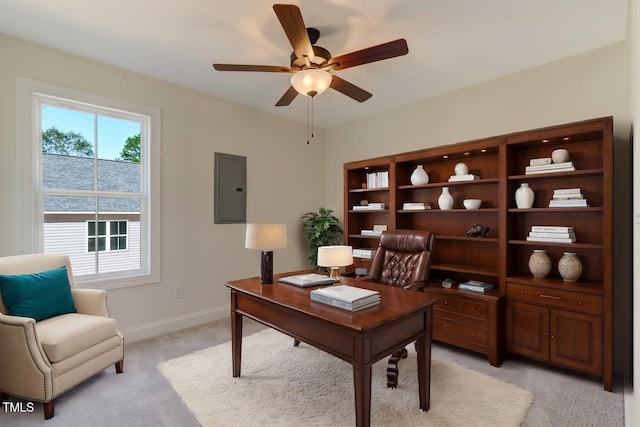 office space featuring ceiling fan, electric panel, baseboards, and light colored carpet