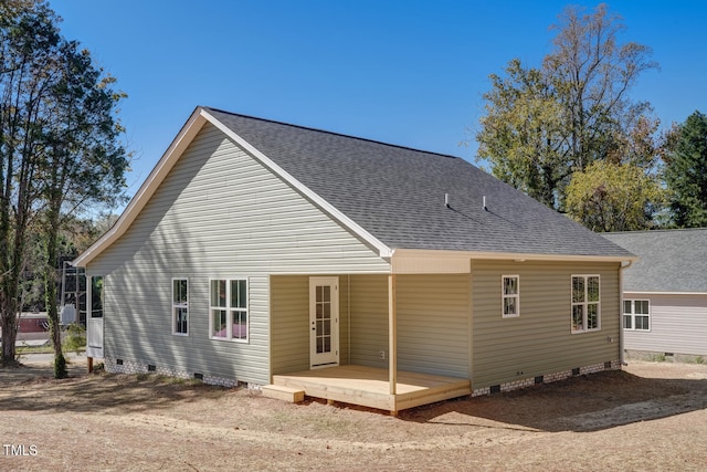 rear view of house with crawl space and roof with shingles