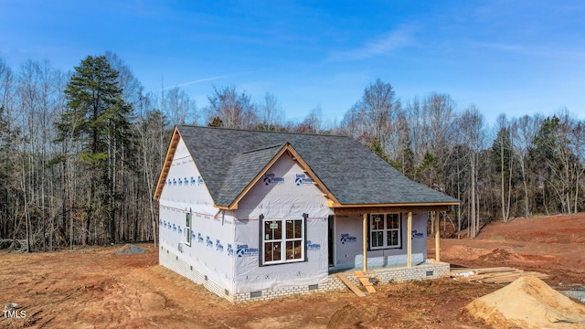 property in mid-construction featuring a shingled roof and crawl space