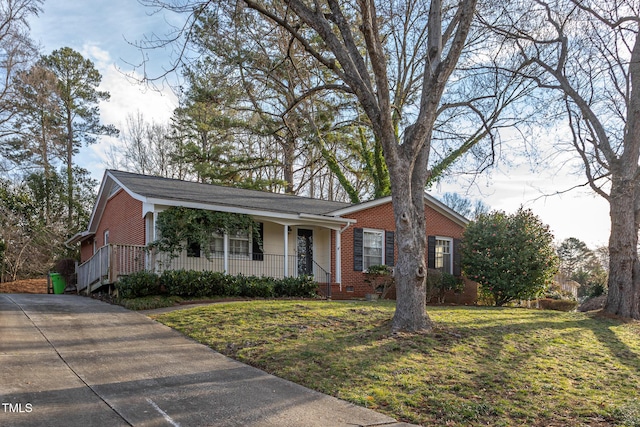 ranch-style house featuring brick siding, crawl space, a porch, and a front lawn