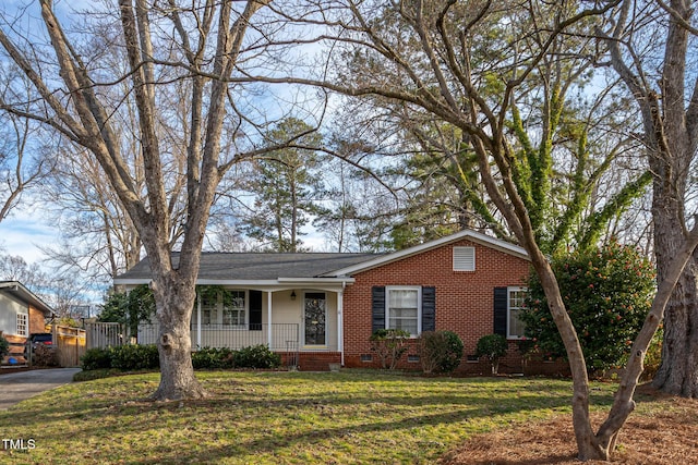 single story home with covered porch, brick siding, crawl space, and a front yard