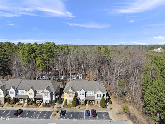 birds eye view of property featuring a residential view and a forest view