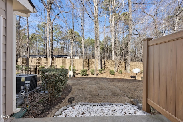 view of yard with cooling unit and fence