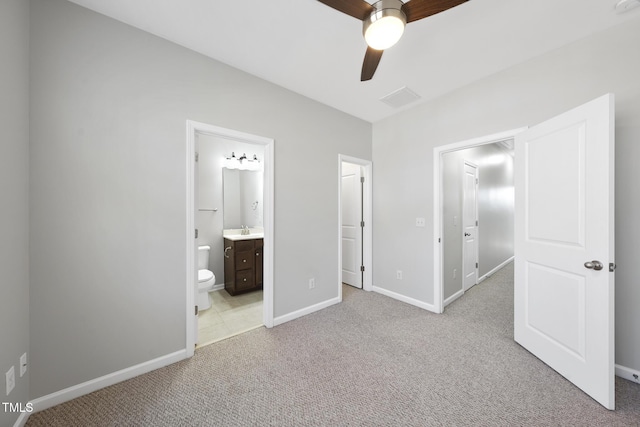 unfurnished bedroom featuring carpet, baseboards, a sink, and ensuite bathroom