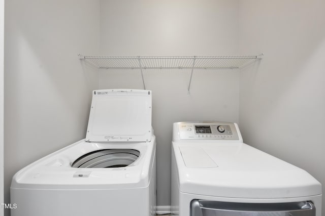 clothes washing area featuring washer and dryer and laundry area