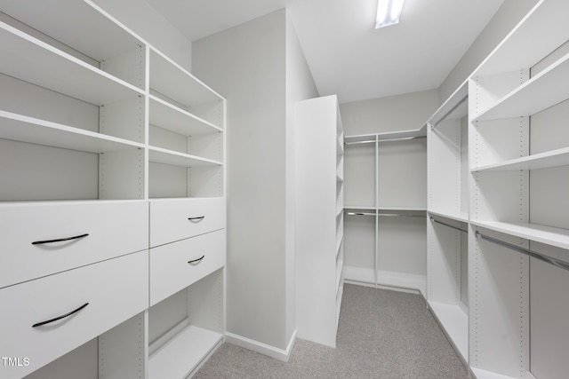 walk in closet featuring light carpet