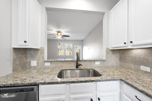 kitchen with a sink, tasteful backsplash, white cabinets, and stainless steel dishwasher