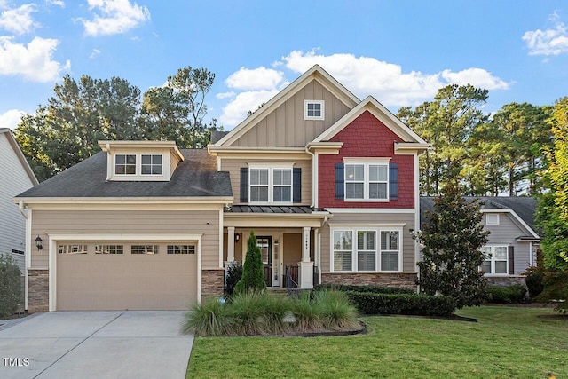 craftsman-style house featuring board and batten siding, stone siding, driveway, and a front lawn