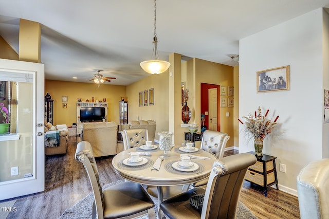 dining area with baseboards, a ceiling fan, and wood finished floors