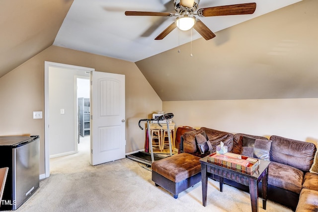 interior space with lofted ceiling, a ceiling fan, baseboards, and light carpet