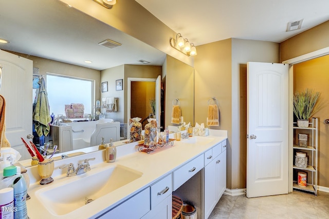 bathroom with tile patterned floors, visible vents, vanity, and baseboards