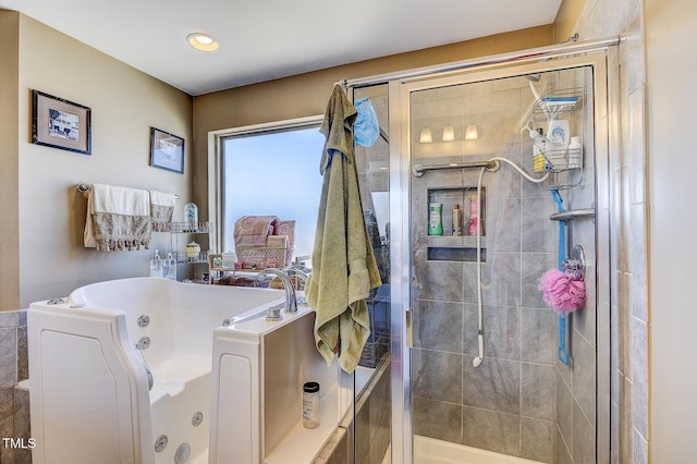 full bath featuring a jetted tub and a stall shower