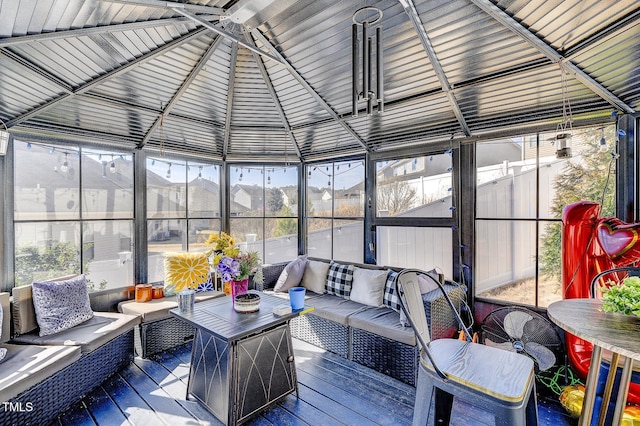 sunroom featuring vaulted ceiling