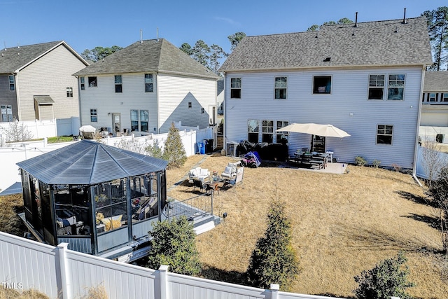 back of property with a patio area and a fenced backyard