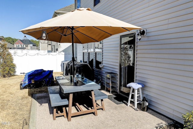 view of patio / terrace with outdoor dining space and fence