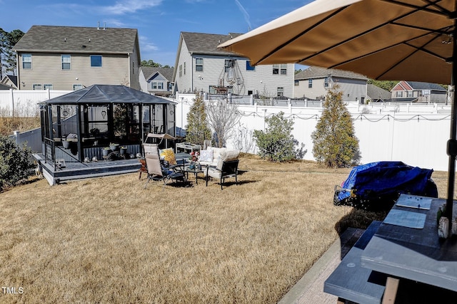 view of yard featuring a gazebo, a residential view, an outdoor fire pit, and fence