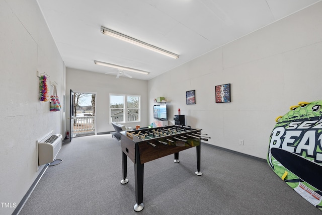 rec room featuring carpet floors, a wall mounted AC, and baseboards