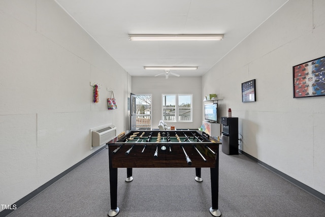 game room with carpet floors, baseboards, and a wall mounted air conditioner