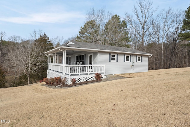 ranch-style house with a porch and a front yard