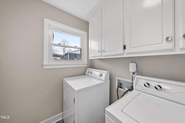 clothes washing area with cabinet space, independent washer and dryer, and baseboards