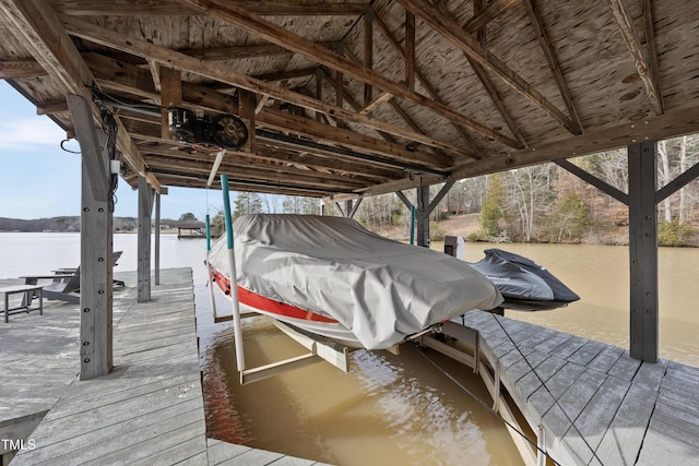 dock area with a water view and boat lift