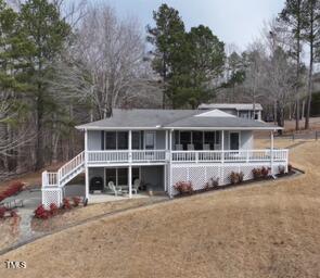 view of front facade with stairs and a front yard