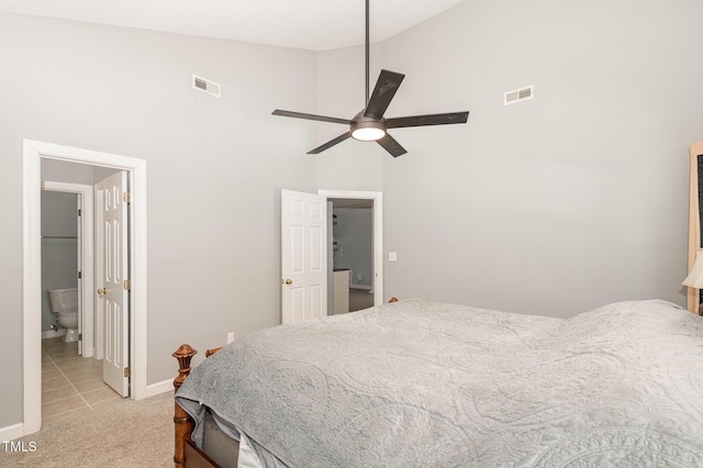 bedroom with baseboards, high vaulted ceiling, visible vents, and light colored carpet