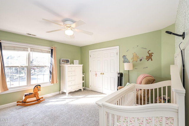 bedroom with baseboards, visible vents, a closet, and carpet flooring