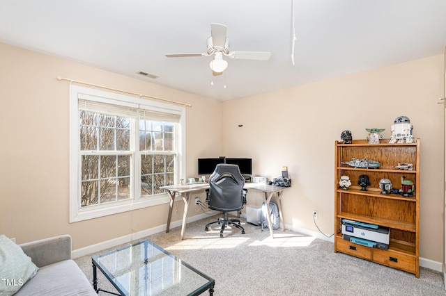 carpeted home office featuring ceiling fan, visible vents, and baseboards