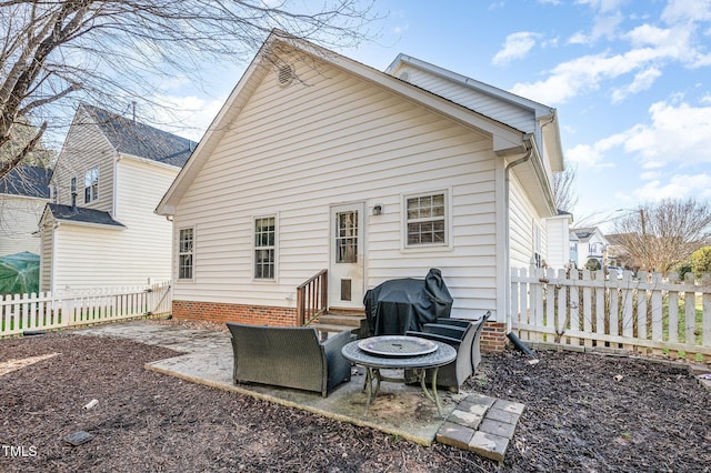 back of house featuring entry steps, a fenced backyard, and a patio