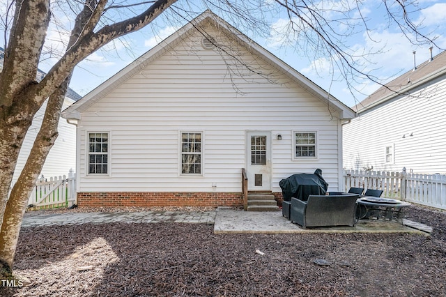 back of property with entry steps and fence