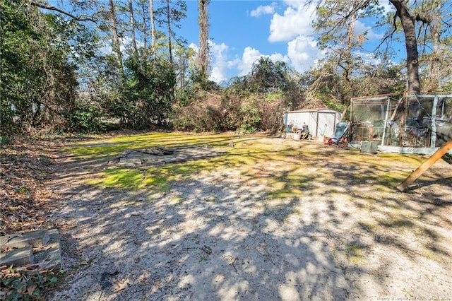 view of yard with a storage shed and an outdoor structure