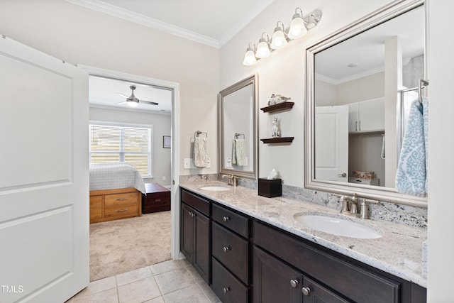 ensuite bathroom featuring double vanity, a sink, and crown molding