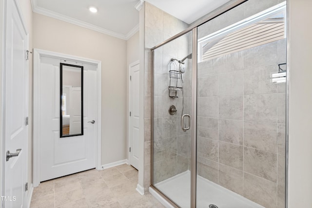 full bath with ornamental molding, a stall shower, and baseboards