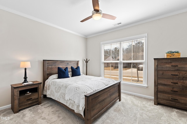 bedroom with ornamental molding, light colored carpet, visible vents, and baseboards