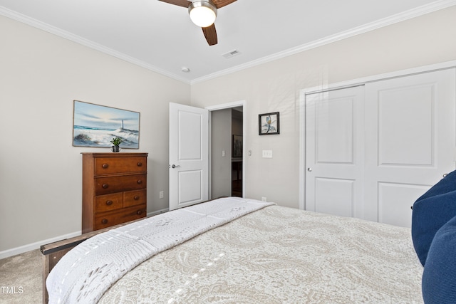 bedroom featuring visible vents, baseboards, ornamental molding, a closet, and carpet