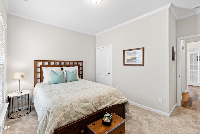 bedroom with baseboards, carpet flooring, and ornamental molding