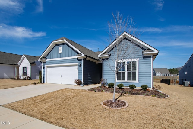 view of front facade with a garage, concrete driveway, a front lawn, and board and batten siding