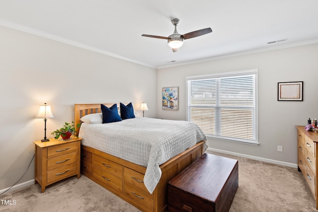 bedroom with light carpet, baseboards, visible vents, ceiling fan, and ornamental molding