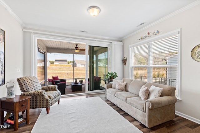 living room featuring ornamental molding, ceiling fan, baseboards, and wood finished floors